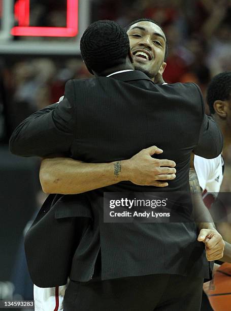 Peyton Siva of the Louisville Cardinals celebrates with program assistant Andre McGee after Sosa hit the winning shot in overtime to beat the...