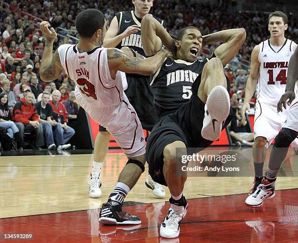 Peyton Siva of the Louisville Cardinals and Lance Goulbourne of the Vanderbilt Commodores battle for a rebound during the game at KFC YUM! Center on...