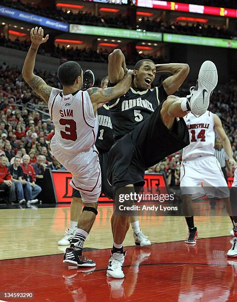 Peyton Siva of the Louisville Cardinals and Lance Goulbourne of the Vanderbilt Commodores battle for a rebound during the game at KFC YUM! Center on...