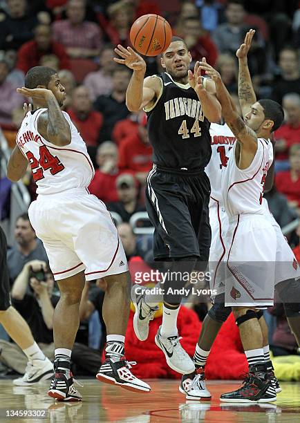 Chane Behanan and Peyton Siva of the Louisville Cardinals defend Jeffrey Taylor of the Vanderbilt Commodores during the game at KFC YUM! Center on...
