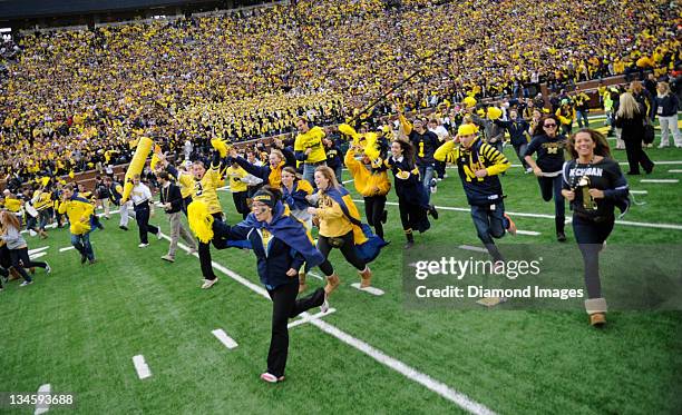 Student from the University of Michigan rush the field after a game between the Ohio State Buckeyes and Michigan Wolverines at Michigan Stadium in...