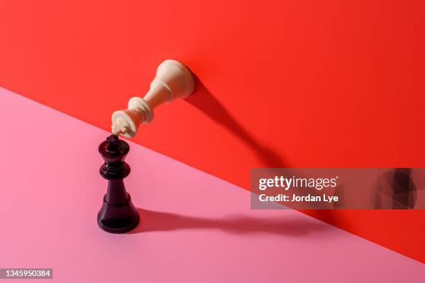 two king chess pieces on a color background - schach stock-fotos und bilder
