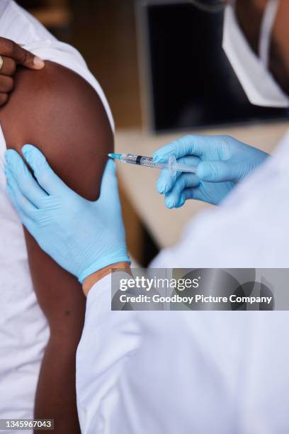 Vaccinating Closeup Of A Doctor Vaccinating A Male Patient High-Res Stock Photo ...