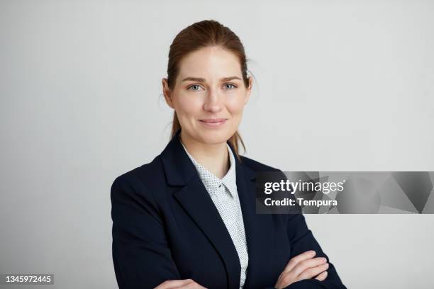 a smiling businesswoman headshot portrait. - portrait gray background stock pictures, royalty-free photos & images