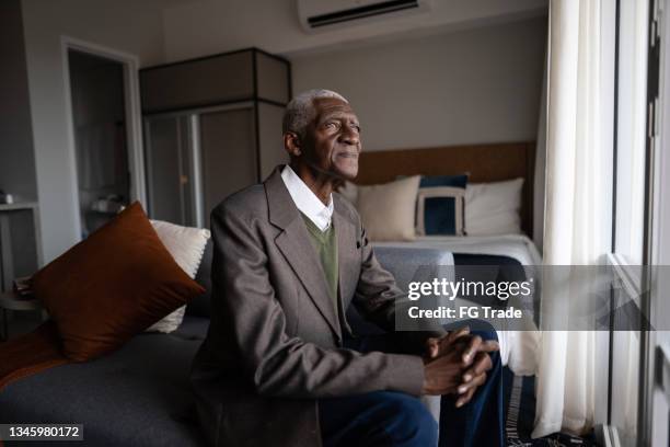 contemplative senior man at home - senior man sad stock pictures, royalty-free photos & images
