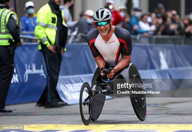 Ernst van Dyk of South Africa crosses the finish line in third place during the men's wheelchair division race of the 125th Boston Marathon on...