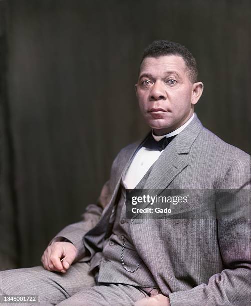 Three quarter length portrait of Civil Rights activist Booker T Washington seated, 1895. Note: Image has been digitally colorized using a modern...