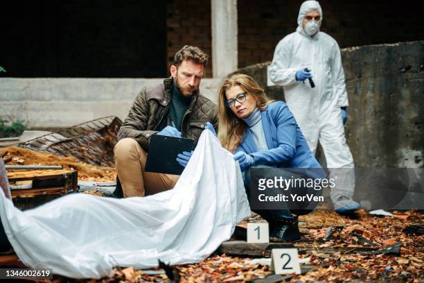detectives and forensic analyst on a murder crime scene collecting evidence - gory of dead people stock pictures, royalty-free photos & images