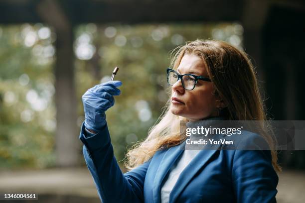 detective on murder crime scene collecting evidence - criminology stock pictures, royalty-free photos & images