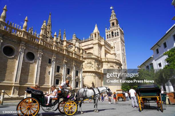 Large number of tourists by the environment of the Cathedral of Seville, during the Puente del Pilar to 11 October 2021 in Seville, Spain. The...