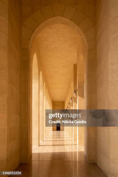 mosque corridor with straight shadows during the day. - arch stock pictures, royalty-free photos & images