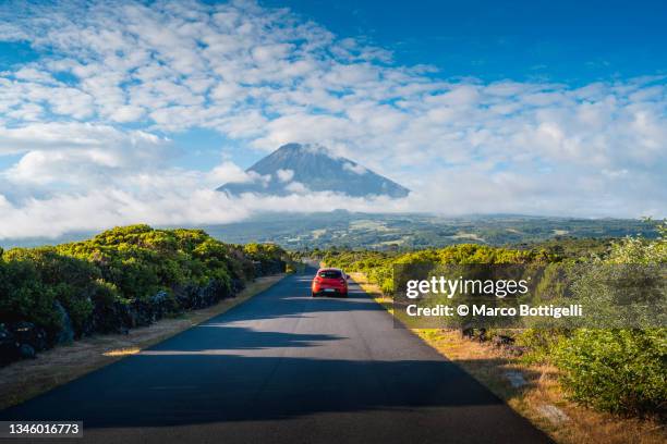 car driving on a mountain road towards mount pico, azores, portugal - car imagens e fotografias de stock