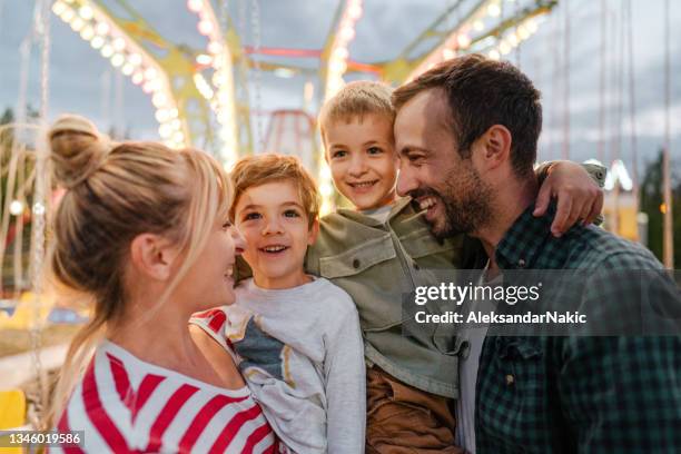 happy family at the amusement park - families having fun stock pictures, royalty-free photos & images