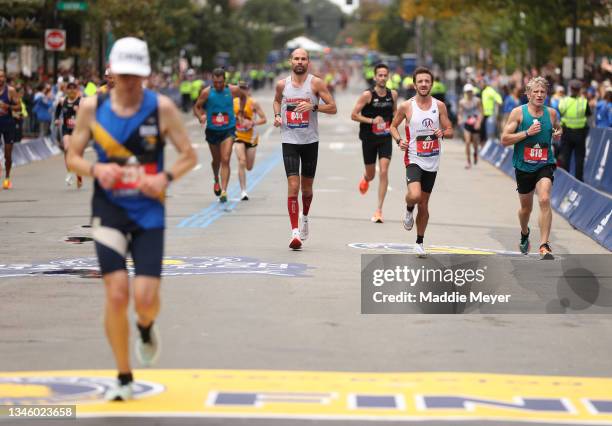 Runners near the finish line during the 125th Boston Marathon on October 11, 2021 in Boston, Massachusetts.