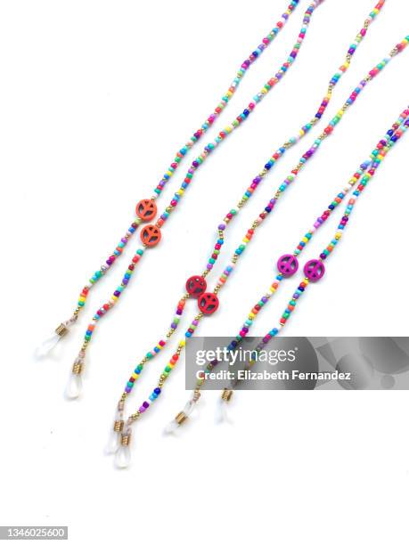 close-up of beaded jewelry on white background. copy space on image. - perlenschmuck stock-fotos und bilder