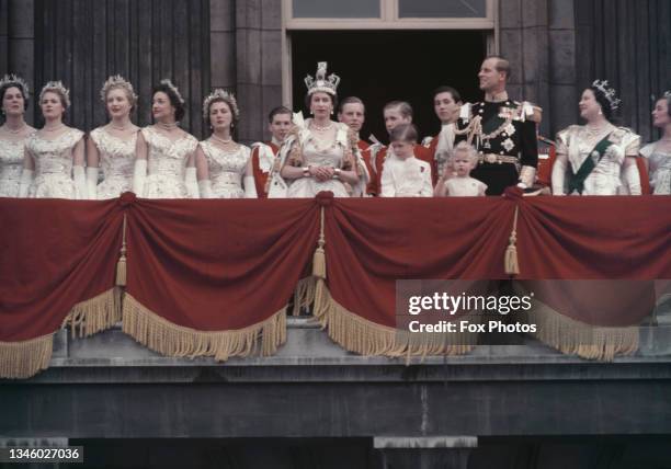 Queen Elizabeth II and the Duke of Edinburgh wave at the crowds from the balcony of Buckingham Palace in London, after Elizabeth's coronation, 2nd...