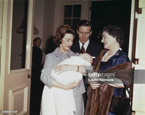 The Queen Mother says goodbye to Princess Margaret and Lord Snowdon on the steps of Clarence House as they take their newborn son Viscount Linley...