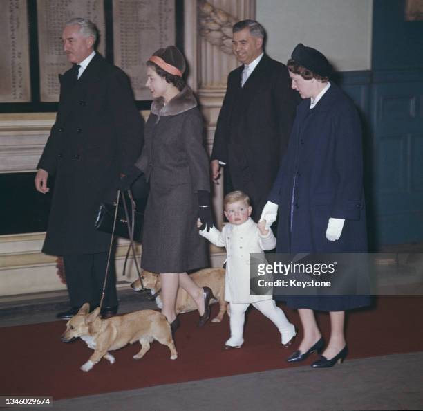 Queen Elizabeth II, Prince Andrew and two corgis at Liverpool Station in London, upon their return from Sandringham, UK, February 1962. On the right...