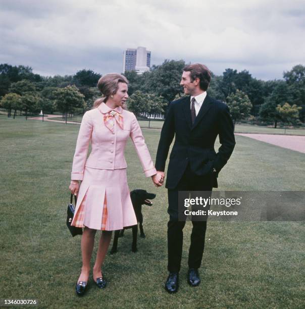 Princess Anne with her fiancé, equestrian champion Mark Phillips in the grounds of Buckingham Palace in London, following the announcement of their...