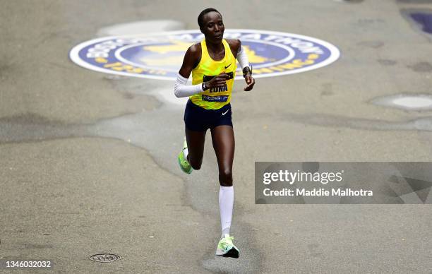 Edna Kiplagat of Kenya crosses the finish line for second place during the 125th Boston Marathon on October 11, 2021 in Boston, Massachusetts.