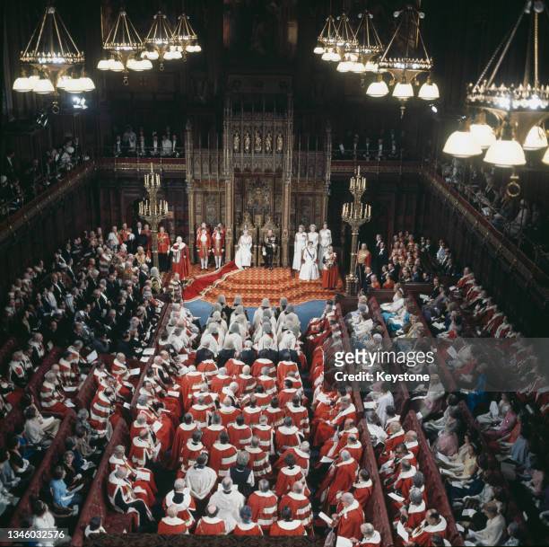 Queen Elizabeth II and Prince Philip, Duke of Edinburgh sit on their thrones as the Queen delivers the Queen's Speech in the House of Lords chamber...