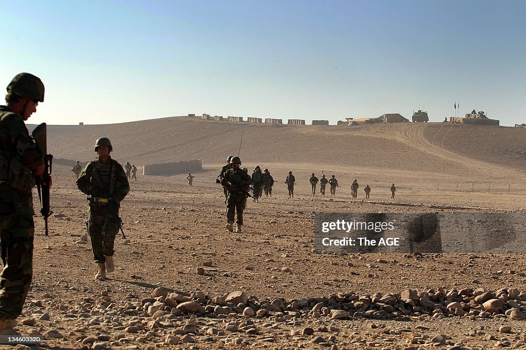 The Australian and Afghan National Army head out from their base to patrol an area of homes at