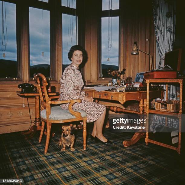 Queen Elizabeth II at the writing desk in her study in Balmoral Castle, Scotland, 1972.