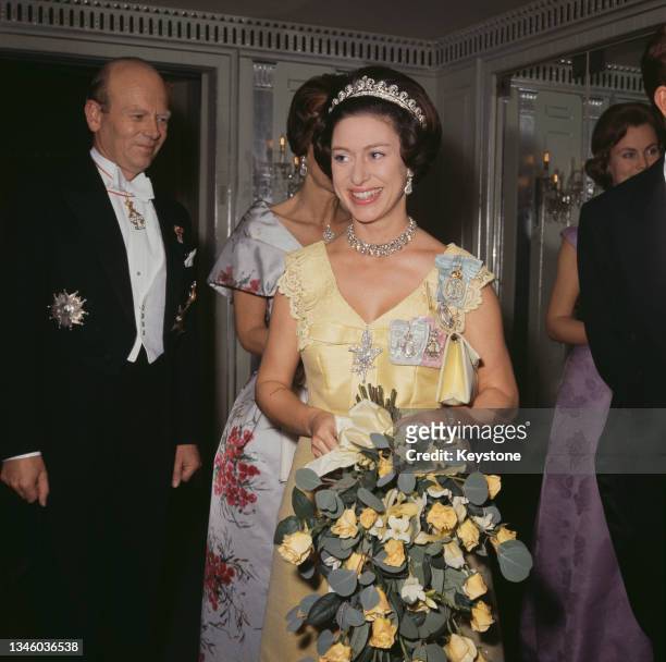 Princess Margaret wearing a yellow evening dress, circa 1970.