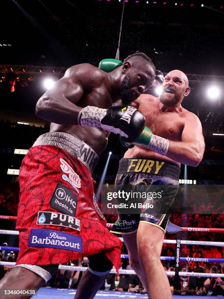 Tyson Fury punches Deontay Wilder during their WBC heavyweight championship at T-Mobile Arena on October 09, 2021 in Las Vegas, Nevada.