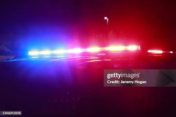 led police lights illuminated on police car at crime scene - police car lights stock pictures, royalty-free photos & images