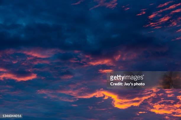 dramatic sunset cloudscape with multiple layers clouds. - daylight savings stock pictures, royalty-free photos & images