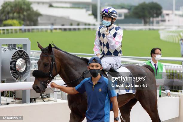 October 10: Jockey Jerry Chau Chun-lok riding Harmony Win Win wins the Race 6 Yan Chai Trophy at Sha Tin Racecourse on October 10, 2021 in Hong Kong.