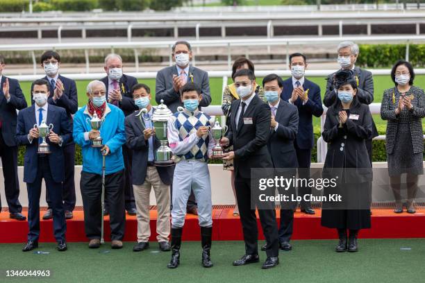 October 10: Jockey of Harmony Win Win, Jerry Chau Chun-lok receives the trophy after winning the Race 6 Yan Chai Trophy at Sha Tin Racecourse on...