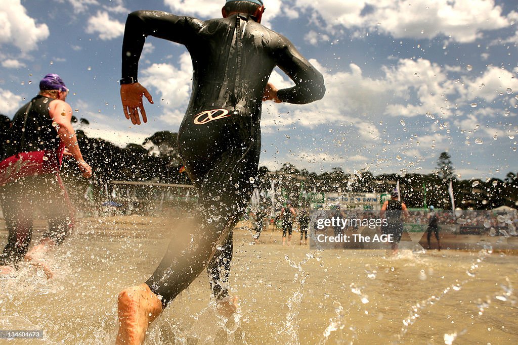 Competitors in the Lorne 'Pier to Pub' Swim run out of the water to the finish line, 5 January 2