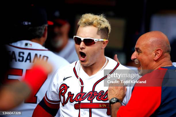 Joc Pederson of the Atlanta Braves reacts to hitting a three run home during the fifth inning against the Milwaukee Brewers in game 3 of the National...