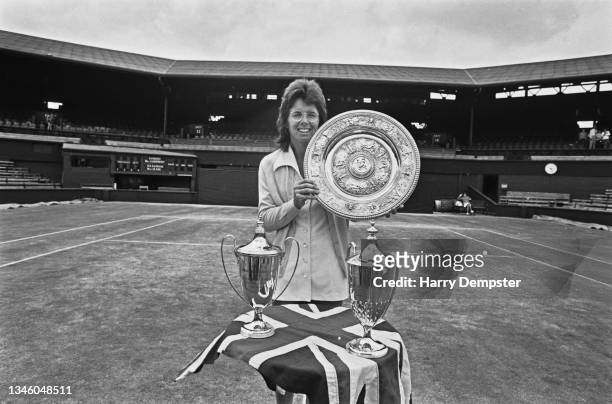 American tennis player Billie Jean King with her trophies at Wimbledon after the Championships, UK, 8th July 1973. She is holding the trophy for the...