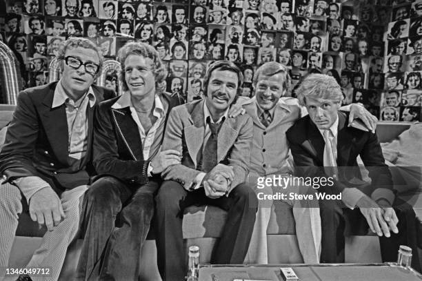 American actor Burt Reynolds with the male stars lined up for his television chat show, 'Burt Reynolds in London', London, UK, 2nd July 1973. The...