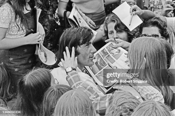 Romanian tennis player Ilie Nastase at Wimbledon in London with his fans, during the Men's Singles, UK, 2nd July 1973.