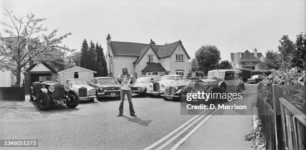 English keyboardist Rick Wakeman of progressive rock group Yes with some of his cars, UK, July 1973.