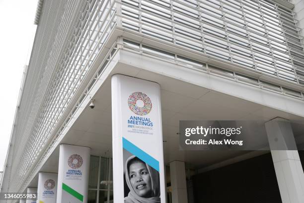 Signs of the annual World Bank Group and International Monetary Fund meetings are seen on the World Bank Group Building October 11, 2021 in...