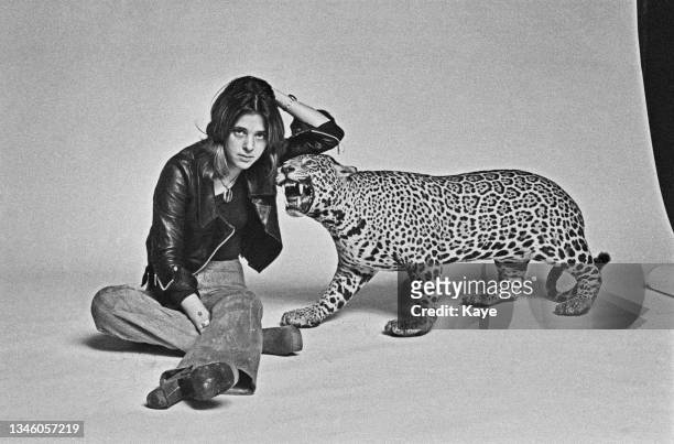 American singer-songwriter and musician Suzi Quatro poses with a stuffed leopard, UK, August 1973.