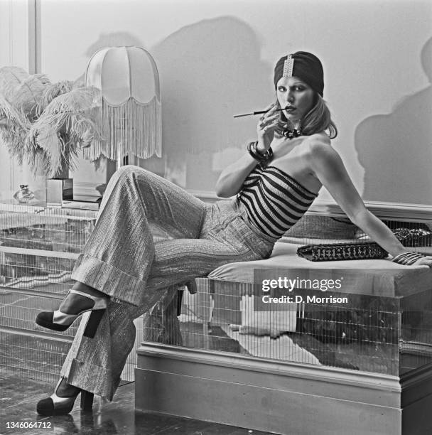 Model wearing wide-legged trousers, a striped tube top and a turban-style hat at the Biba boutique in London, UK, 6th September 1973.