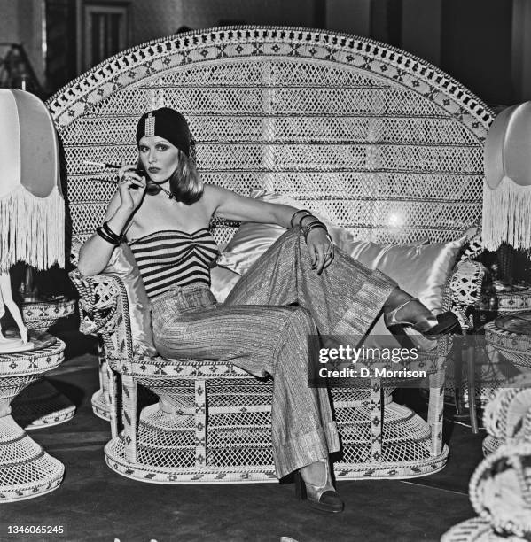 Model wearing wide-legged trousers, a striped tube top and a turban-style hat at the Biba boutique in London, UK, 6th September 1973.