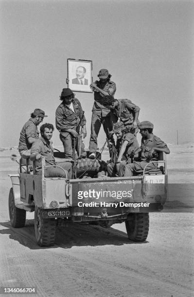 Egyptian soldiers holding up a portrait of Egyptian President Anwar Sadat during the Yom Kippur War around the Sinai Peninsula and Golan Heights,...