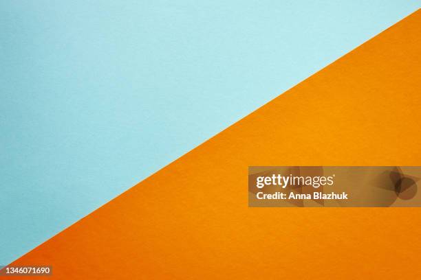 multi-colored paper geometric abstract background of blue and orange colors. - hintergrund papier orange stock-fotos und bilder