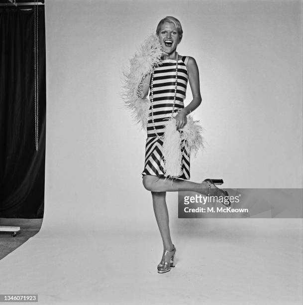 Model Anne Addison wearing a striped day dress with a 1920s drop waist, UK, 13th November 1973.