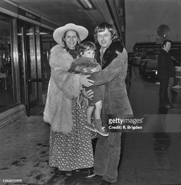 German-American pianist and conductor André Previn with his wife, actress Mia Farrow and their child at Heathrow Airport in London, UK, 8th December...
