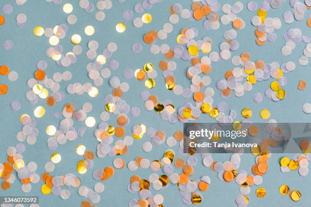orange, gold confetti on blue background. festive holiday backdrop. birthday congratulations. valentines day. happy halloween. flat lay, top view, copy space - october birthday stock pictures, royalty-free photos & images