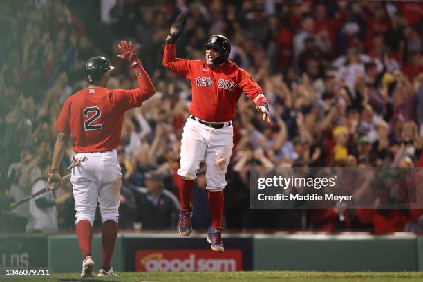 Christian Vazquez of the Boston Red Sox celebrates with Xander Bogaerts after scoring on a three-run homerun by Rafael Devers in the third inning...