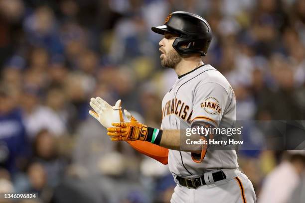 Evan Longoria of the San Francisco Giants reacts after his solo home run against the Los Angeles Dodgers during the fifth inning in game 3 of the...